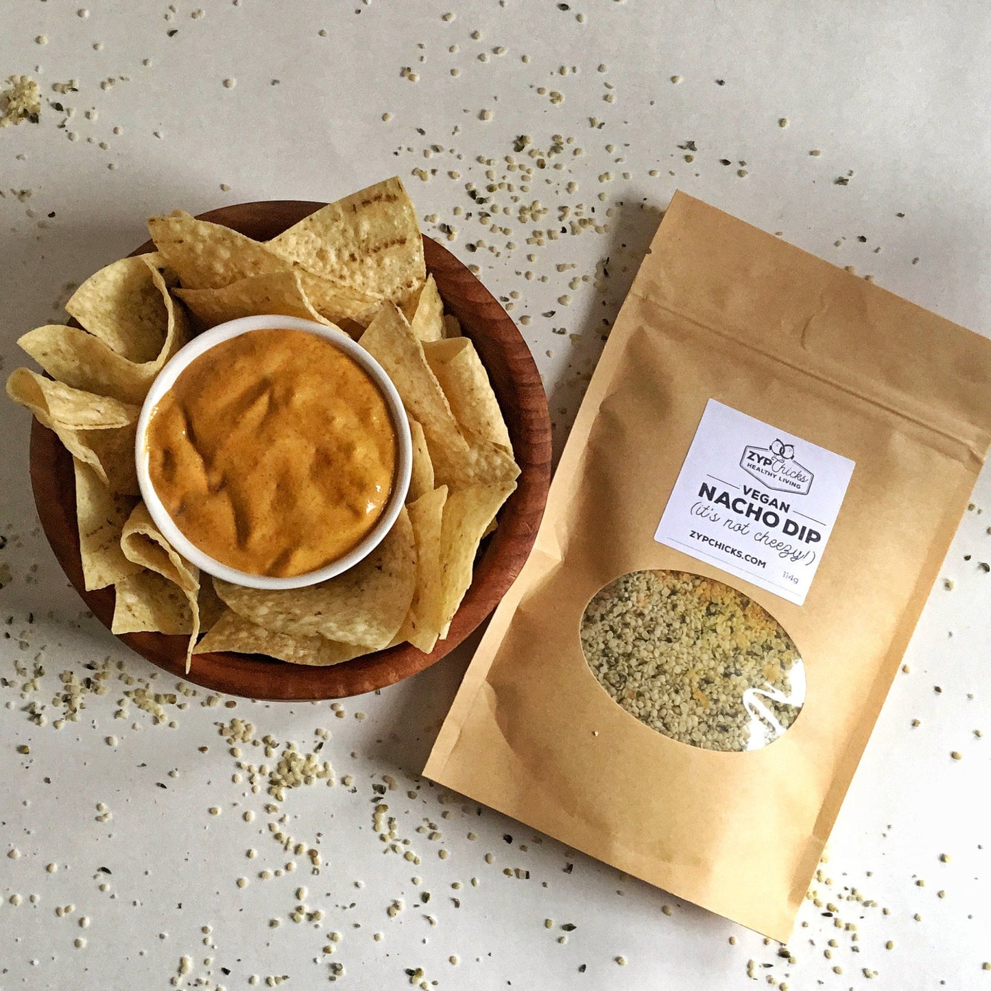 ZypChicks Vegan Nacho Dip surrounded by a platter of organic nacho corn chips.